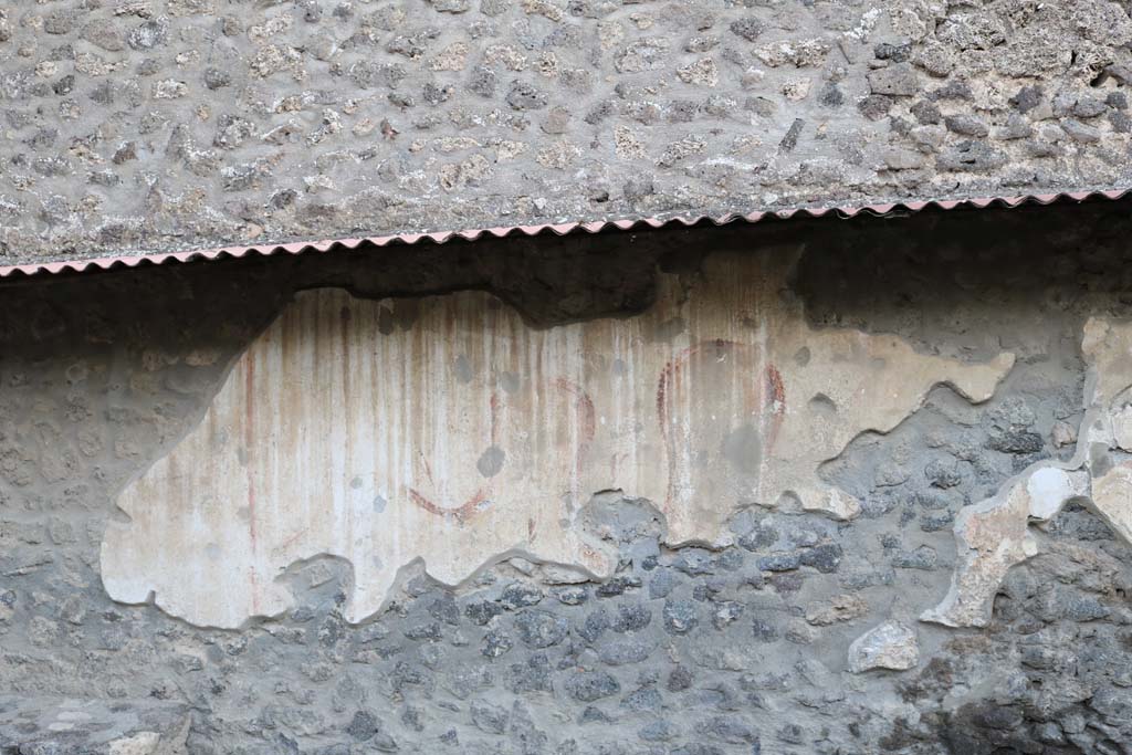 Pompeii Street Altar at I.8.1. December 2018. North end of remains of painting to north of altar. Photo courtesy of Aude Durand.