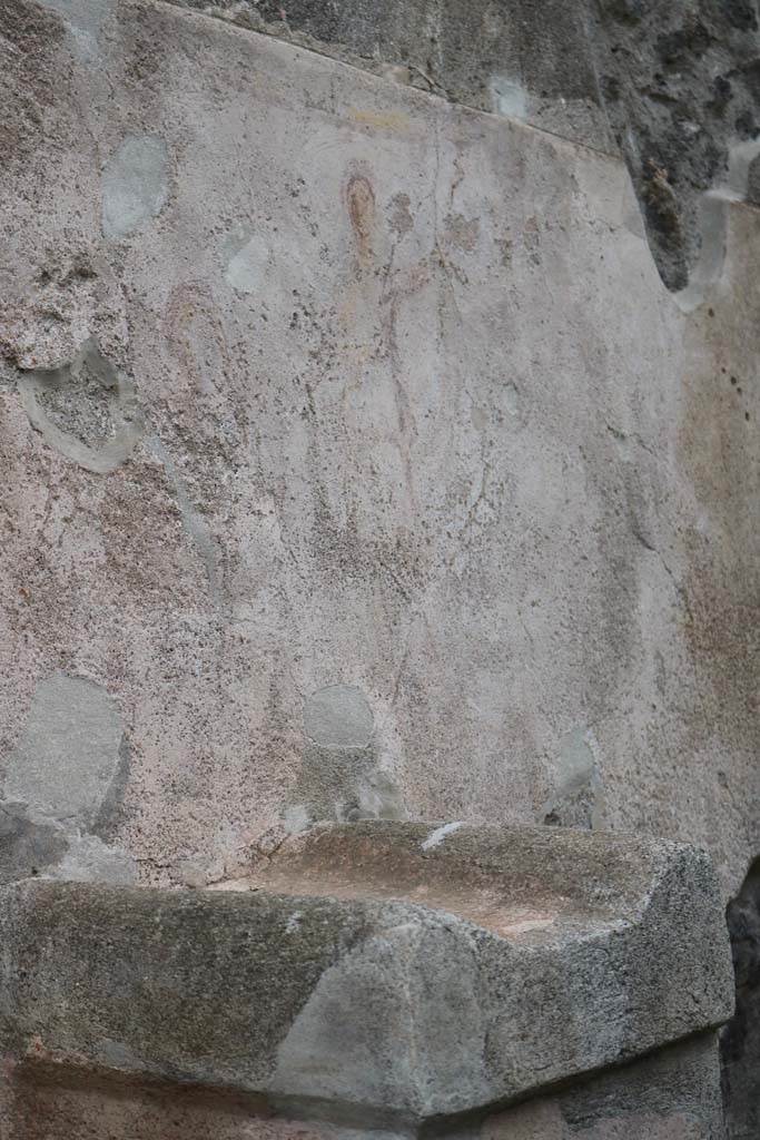 Street altar on west side wall of I.11.1. December 2018.
Detail of top of altar with remains of painting of street shrine, above. Photo courtesy of Aude Durand.