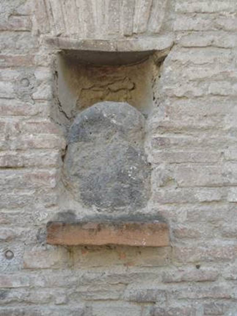 Street altar outside I.12.5, Pompeii. October 2011.
Rectangular niche on the left side of the doorway with a blue lava stone. Photo courtesy of Daniel Genot.