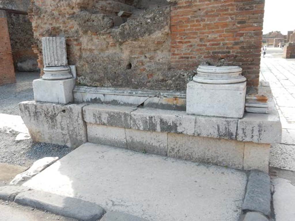 Arch at north-east end of the Forum. May 2015. Remains of marble base and pillars on north face of east side below fountain.
Photo courtesy of Buzz Ferebee.