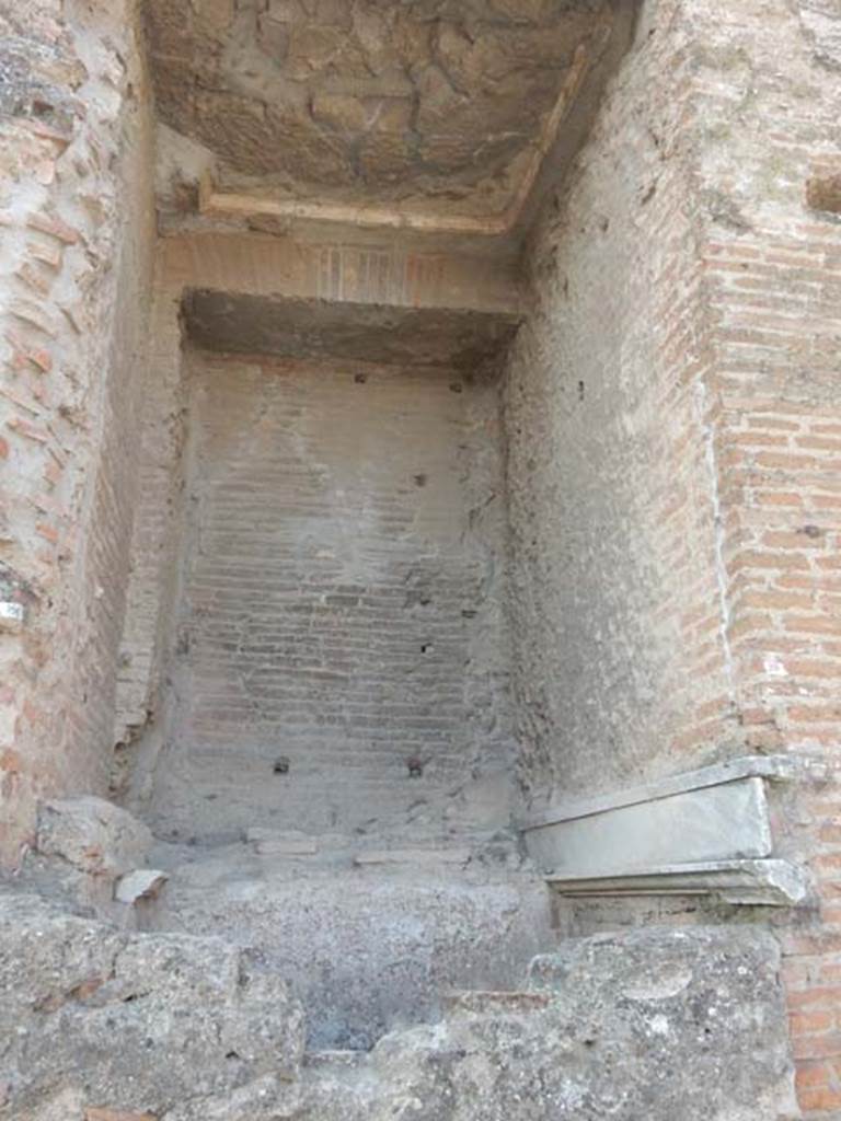 Arch at north-east end of the Forum. May 2015. Remains of marble and fountain on north face of east side.
Photo courtesy of Buzz Ferebee.