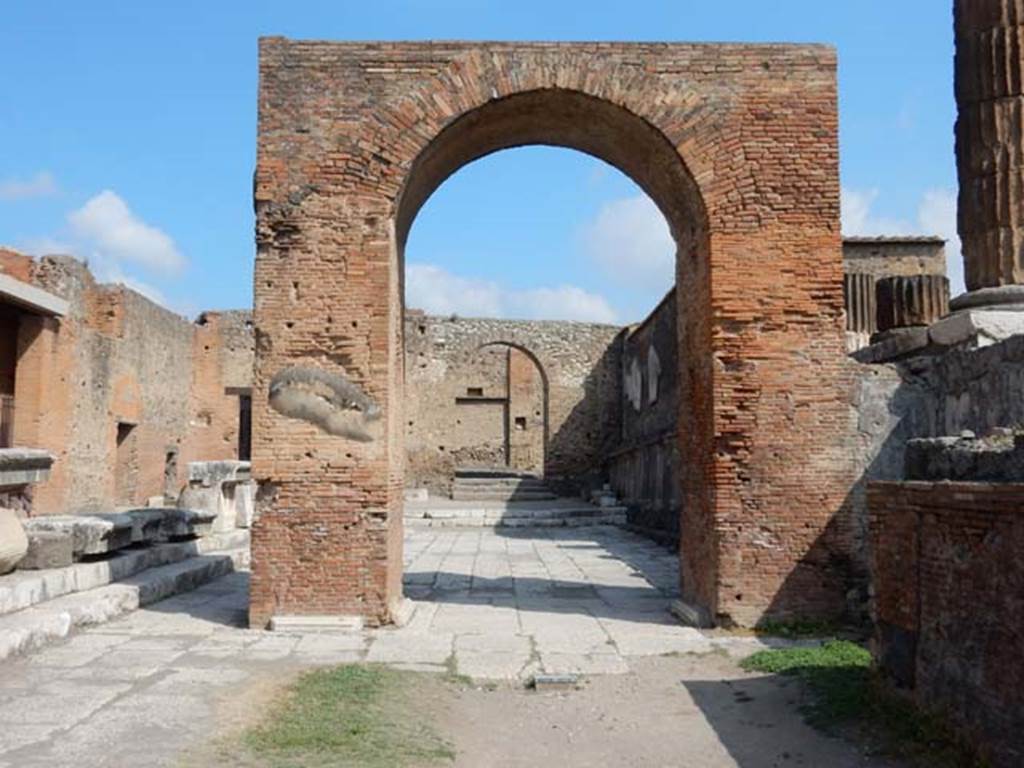 Arched entrance in north-west corner of Pompeii Forum, May 2015. Looking north through the Arch of Augustus to the arched entrance with its steps. Photo courtesy of Buzz Ferebee.
On ADS 1210a the arch is referred to as the Arco di Caio e Lucio Cesare.
Caius/Gaius Julius Caesar and Lucius Julius Caesar were sons of Marcus Vipsanius Agrippa and Giulia the Elder, daughter of Augustus.
They were part of the imperial family of Augustus, known as the Julio-Claudian dynasty.
The year of their father's death (12 BC), their maternal grandfather, Augustus adopted them and named them as his heirs.
They grew up and were educated by their grandparents but did not succeed Augustus as they died before him, in 4 AD and 2 AD respectively.
