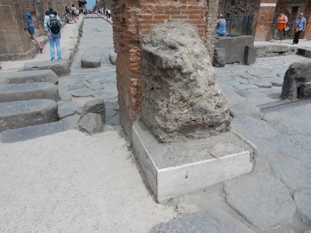 Arch of Marcus Holconius Rufus. May 2017. North-east pillar with remains of another statue base. Looking east along Via dell’Abbondanza from junction with Via Stabiana. Photo courtesy of Buzz Ferebee.