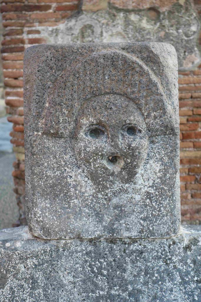 Fountain outside I.4.15 on Via Stabiana.
December 2018. Fountain head with relief of comedy mask. Photo courtesy of Aude Durand.