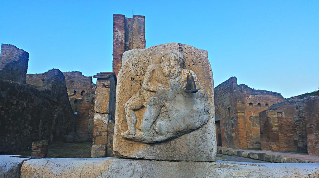 Fountain outside VI.14.17, Pompeii. December 2019.
Detail of marble relief of Silenus on pilaster of fountain. Photo courtesy of Giuseppe Ciaramella.