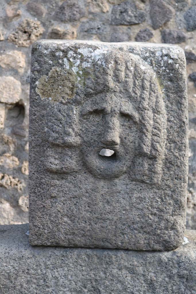 Fountain outside VII.11.5 on Vicolo della Maschera. December 2018.
Relief of tragic mask. Photo courtesy of Aude Durand.