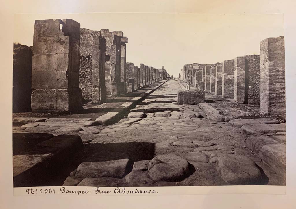 Fountain outside VII.14.13 and VII.14.14 on Via dell’Abbondanza. From an album of Michele Amodio dated 1874, entitled “Pompei, destroyed on 23 November 79, discovered in 1748”.
Looking west to crossroads with Via dei Teatri, on left, and Vicolo del Lupanare, on right.
Photo courtesy of Rick Bauer.