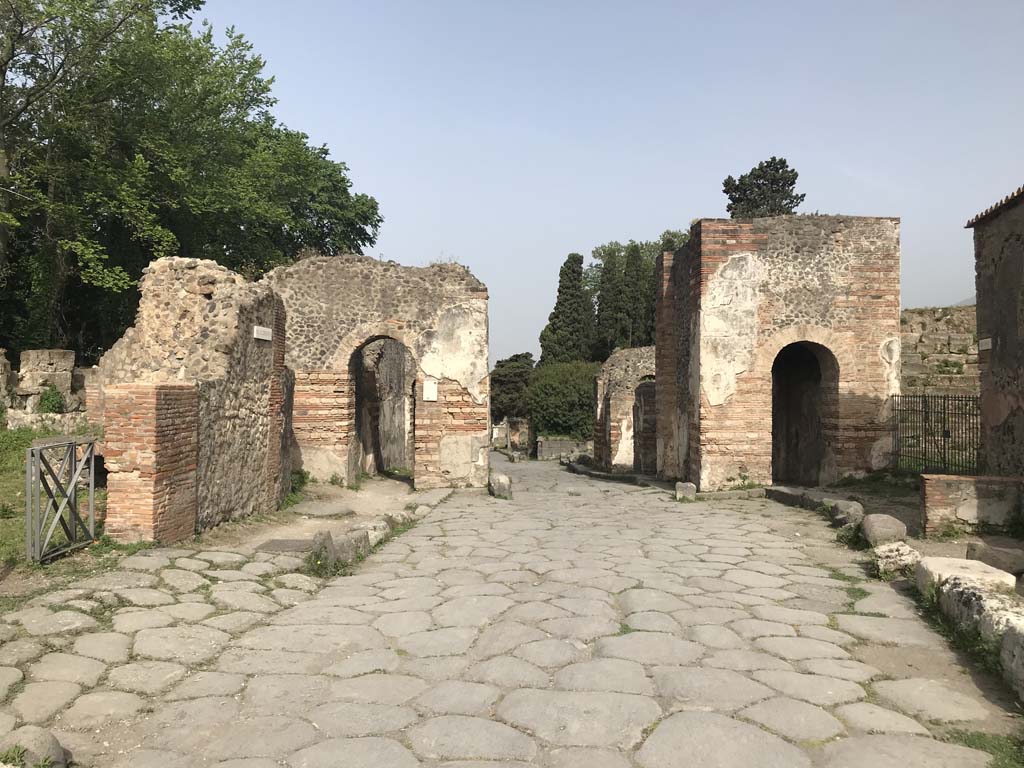 Porta Ercolano or Herculaneum Gate, Pompeii. April 2019. Looking north on Via Consolare. Photo courtesy of Rick Bauer.
According to Van der Graaff –
“The Porta Ercolano was the most monumental structure among the Pompeian gates (see Fig.3.9).
The ruins exposed today represent its Flavian version, built as a monumental arch crowning the reconstruction effort following the earthquakes of the 60s CE (Note 72).
Its form is the result of the gate’s special status because of its position at the head of the Via Consolare, a busy regional road connecting Pompeii with Naples and, through the Via Domitiana, on to Rome (Note 73).”
See Van der Graaff, I. (2018). The Fortifications of Pompeii and Ancient Italy. Routledge, (p. 62 and Note 72 and 73).
And –
“The veru sarinu (salt gate), identified as the Porta Ercolano, received its name because it opened onto nearby salt (sarinu in Oscan – salienses in Latin) flats. (Note 132).”
See Van der Graaff, I. (2018). The Fortifications of Pompeii and Ancient Italy. Routledge, (p.106 and 107 and Note 132).