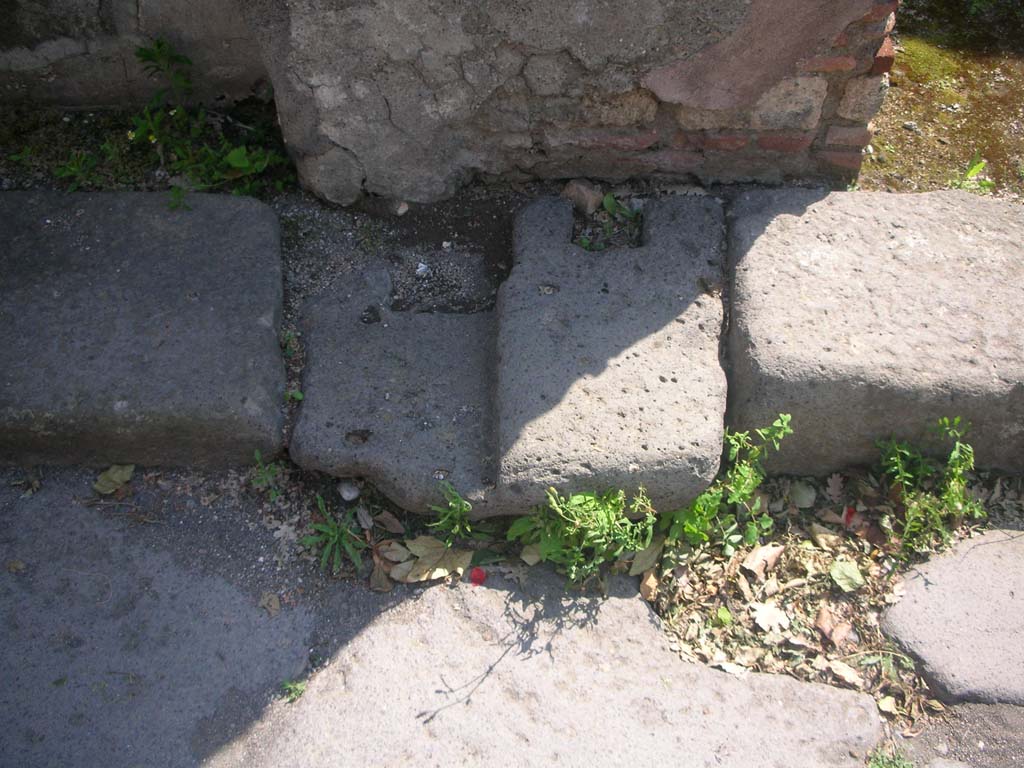 Porta Ercolano or Herculaneum Gate, Pompeii. May 2010.
Roadway through gate, detail from west side of gate at south end, area of “double-leaf gate”. Photo courtesy of Ivo van der Graaff.
According to Van der Graaff –
“The gate features a large central roadway open to cart traffic with two smaller flanking pedestrian passageways on either side.
Barrel vaults covered the side passages, whereas the central bay was open to the sky.
A portcullis on the exterior and a double leaf gate on the interior closed the passageway on either end. The result was a typical open court plan …………
Open court gates had a clear military function to trap attackers and allow defenders to bombard them from an elevated position……………
It never achieved full military functionality since the current remains do not indicate an easy access to the second floor.
Instead, the gate is almost exclusively a monumental structure that resembles a triumphal arch.”
See Van der Graaff, I. (2018). The Fortifications of Pompeii and Ancient Italy. Routledge, (p.129).