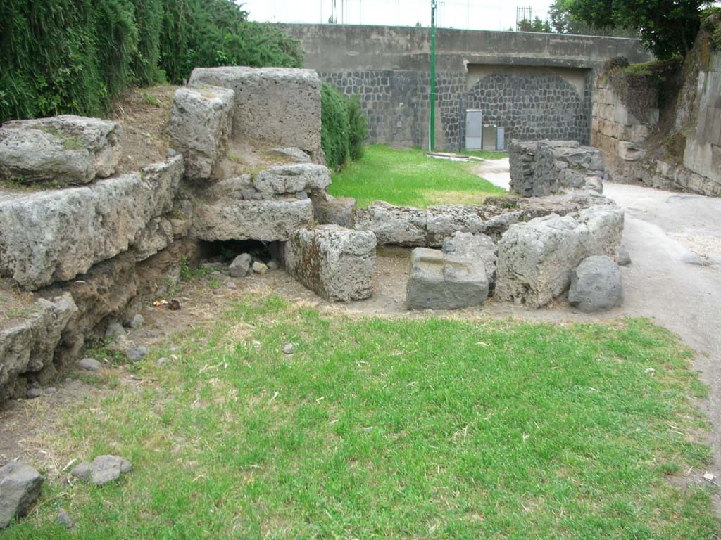 Porta di Sarno or Sarnus Gate. May 2010.
Remains of entrance to drain (centre left) on north side of gate, looking east. Photo courtesy of Ivo van der Graaff.
According to Van der Graaff –
“The Porto Sarno is perhaps the most damaged of the standing gates. The entire north flank is missing as a result of the Allied bombing in WWII.
Only the lowest course, parts of the opus incertum vault, and traces of a drain remain.”
See Van der Graaff, I. (2018). The Fortifications of Pompeii and Ancient Italy. Routledge, (p.62, and Fig.3.8).
