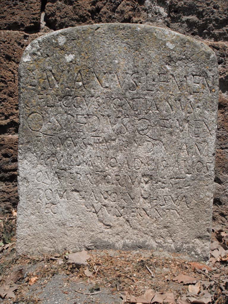 Porta Stabia, Pompeii. May 2011.
Detail from Cippus of L. Avianius Flaccus and Q. Spedius Firmus against south wall on east side. Photo courtesy of Ivo van der Graaff.
According to Van der Graaff –
“At the Porta Stabia the renovations conducted by the duumviri L. Avianius Flaccus and Q. Spedius Firmus included the construction of a raised causeway in front of the gate to ease cart traffic from the bustling river port nearby (Note 64).
The new roadway compromised the natural drainage of rainwater through the passageway, eventually leading to the construction of a sewer through the western agger that demolished the stairs leading up to the wall-walk (note 65).
The causeway also bridged the defensive ditch in front of the gate, thereby significantly reducing its military effectiveness.”
See Van der Graaff, I. (2018). The Fortifications of Pompeii and Ancient Italy. Routledge, (p.126).