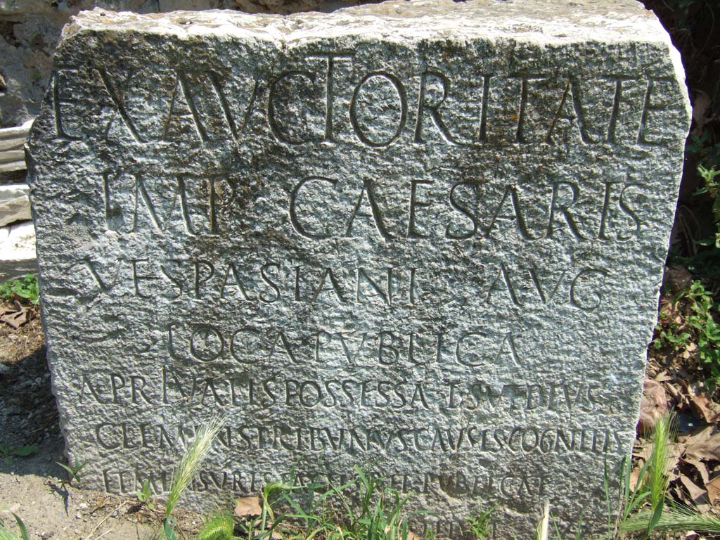 Vesuvian Gate Pompeii. May 2006. VG5 Cippus of Titus Suedius Clemens. The Cippus is inscribed:
Ex auctoritate
imp(eratoris) Caesaris
Vespasiani Aug(usti)
loca publica
a privatis possessa T(itus) Suedius
Clemens tribunus causis cognitis
et mensuris factis rei publicae
Pompeianorum restituit.
By virtue of authority conferred upon him by the Emperor Vespasian Caesar Augustus,
Titus Suedius Clemens, tribune, having investigated the facts and taken measurements,
restored to the citizens of Pompeii public places illegally appropriated by private persons.
Similar Cippi were found at the Porta Ercolano, Porta Marina and the Porta Nocera.
The wording “rei publicae Pompeianorum” on one of these, discovered in 1763, was the first positive identification that the site was Pompeii.
Until then scholars had divided opinions on the city buried under Cività. Many, including the first official excavators, thought it was the ancient city of Stabiae.
See Conticello, B., Ed, 1990. Rediscovering Pompeii. Rome: L’Erma di Bretschneider. (p. 225).
