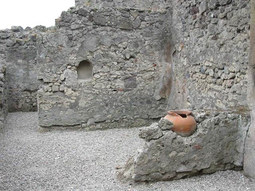 VII.9.49 Pompeii. May 2003. Looking south through entrance doorway. Photo courtesy of Nicolas Monteix.
According to Boyce –
in the south wall of this taberna with thermopolium is an arched niche (h.0.45, w.0.35, d.0.25, h. above floor 1,10.
It was called by Fiorelli, “la nicchia dei Penati”.
See Boyce G. K., 1937. Corpus of the Lararia of Pompeii. Rome: MAAR 14. (p.69, no.305).