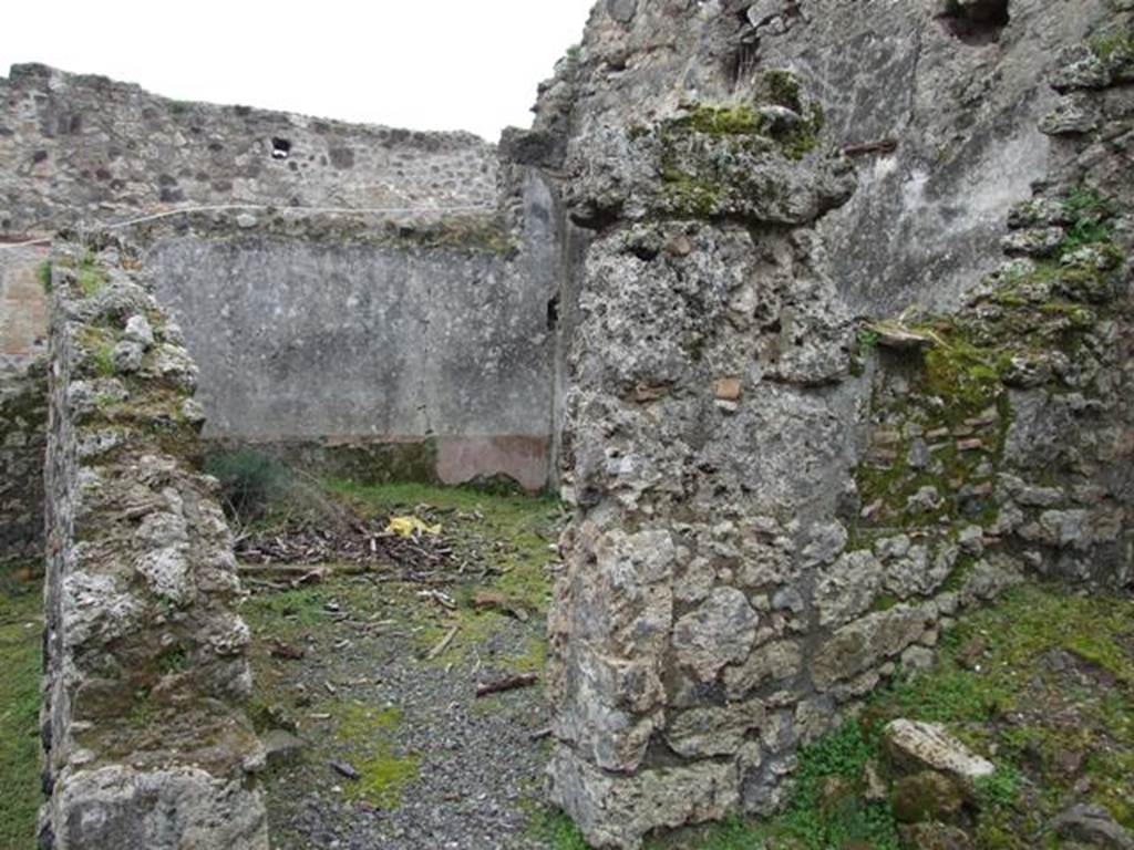 VII.10.12 Pompeii. March 2009. Doorway to triclinium in south-east corner of atrium.
According to Boyce, on the east wall of the atrium entered at number 12 was a lararium painting on a white background.
The Genius, wreathed and wearing a toga with a fold drawn over his head, held a cornucopia in his left hand.
With his right hand, he poured a libation from a patera onto a blazing altar around which a serpent was coiled.
His head was excellently preserved and exhibited the features of the Roman portrait type of the early Empire.
In the wall above the painting was a niche.
See Helbig, W., 1868. Wandgemälde der vom Vesuv verschütteten Städte Campaniens. Leipzig: Breitkopf und Härtel, (31).
See Fiorelli, G., 1875. Descrizione di Pompei. Napoli, p. 276.
See Boyce G. K., 1937. Corpus of the Lararia of Pompeii. Rome: MAAR 14. (p.69, no.309, numbered as VII.x.9-12).