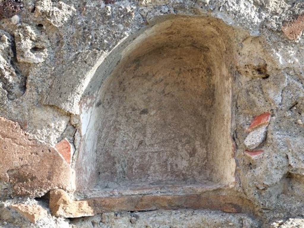 VII.13.7 Pompeii. December 2007. Niche on east wall of dwelling.
According to Boyce –
in the east wall of the back room, above the hearth, was a small arched niche (h.0.33, w.0.30, d.0.18, h. above hearth 0.20).
See Boyce G. K., 1937. Corpus of the Lararia of Pompeii. Rome: MAAR 14. (p.71, no.324, with Pl.2,5)