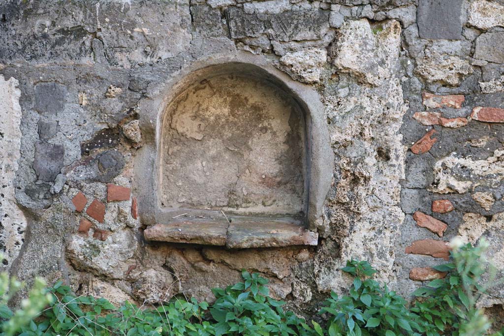 VII.15.11/12 Pompeii. December 2018. Detail of niche in west wall of garden area. Photo courtesy of Aude Durand.
According to Boyce-
in the west wall of the garden was a smaller arched niche (h.0.45, w.0.45, d.0.20, h. above floor only 0.40), which may also have been a lararium.
He also mentioned the shallow rectangular niche in the east wall of the atrium, see VII.15.12 above.
See Boyce G. K., 1937. Corpus of the Lararia of Pompeii. Rome: MAAR 14. (p.72, no.333)
See Giacobello, F., 2008. Larari Pompeiani: Iconografia e culto dei Lari in ambito domestico. Milano: LED Edizioni, (p.282 no.V71)
