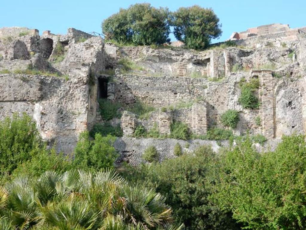 VIII.2.16 Pompeii. May 2015.
Looking north towards lower floor levels beneath area of collapsed terrace garden. Photo courtesy of Buzz Ferebee.
According to Boyce, in a kind of cave beneath the court located behind the large atrium of number 16, on the extreme edge of the slope was a sacrarium of peculiar nature.
Against the rear wall of a narrow passage was built a masonry seat.
In the wall above it, a vaulted opening led into a small cell hewn out of the rock, with its floor 0.50m below that of the outer passage.
A second masonry seat was built within the cell, back to back with that in the outer passage.
The only means of entrance into this inner chamber appeared to have been over these two seats and through the small opening above them.
Within the cella stood a rectangular masonry altar and upon the altar lay a small terracotta altar, a marble ball, and two lamps decorated with reliefs.
One of the lamps was decorated with the relief of Jupiter, the other of a rose.
See Notizie degli Scavi di Antichità, 1890, 290.
See Boyce G. K., 1937. Corpus of the Lararia of Pompeii. Rome: MAAR 14. (p.74, no.344)
See Giacobello, F., 2008. Larari Pompeiani: Iconografia e culto dei Lari in ambito domestico. Milano: LED Edizioni. (p.246)