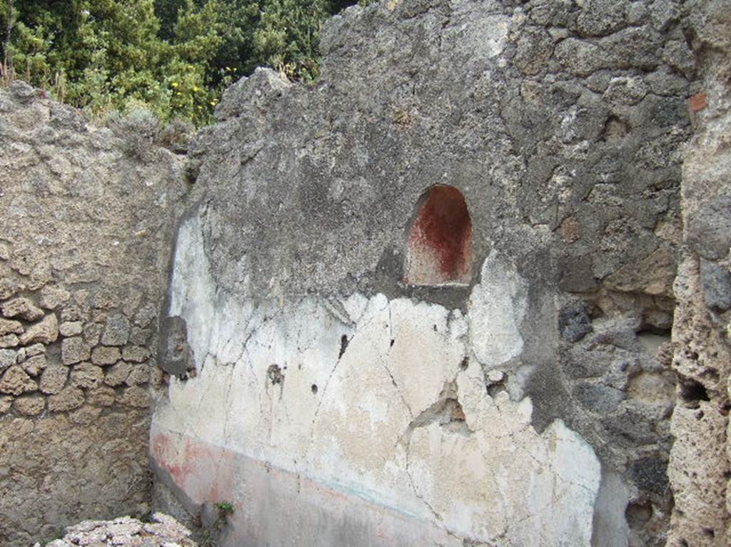 VIII.2.39 Pompeii. May 2006. Lararium niche in small room in north east corner of atrium. This was painted red with a genius in a toga, holding a cornucopia and standing to the left of a round altar. To the right was a figure in blue and yellow with a diadem and sceptre in the left hand and a patera in the outstretched right hand. This was possibly Juno.
See Fröhlich, T., 1991. Lararien und Fassadenbilder in den Vesuvstädten. Mainz: von Zabern. (p. 291, L95, T:44,1).
See Boyce G. K., 1937. Corpus of the Lararia of Pompeii. Rome: MAAR 14. (p. 75, no. 349, pl.19,2).