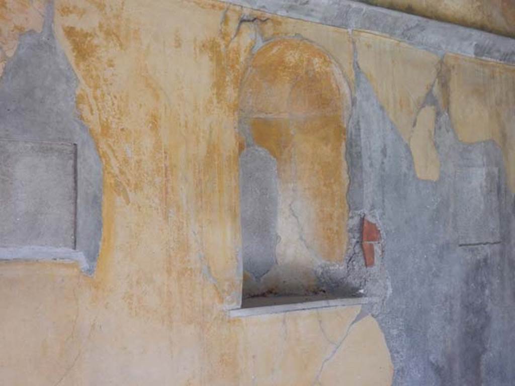 VIII.3.14 Pompeii. May 2016. Detail of niche in south wall. Photo courtesy of Buzz Ferebee.
According to Boyce –
In the south wall of the cubiculum is a semicircular vaulted niche (h.1.00, w.0.60, d.0.30, h. above floor 1.40), its inside walls coated with yellow stucco like the walls of the room, its floor a marble slab; Fiorelli calls it “una nicchia per qualche simulacro di deita”.
See Fiorelli, Descr., 326.
See Boyce G. K., 1937. Corpus of the Lararia of Pompeii. Rome: MAAR 14. (p. 75, no. 352).
