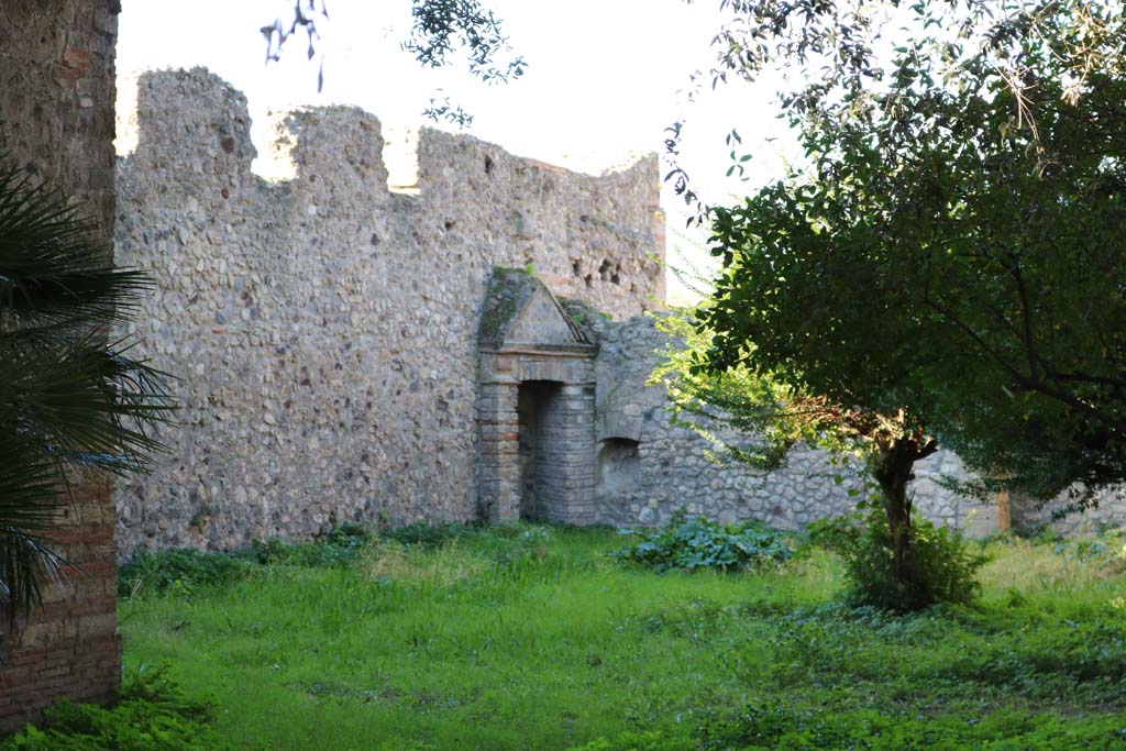 VIII.3.14, Pompeii. December 2018.
Looking towards north-west corner of garden area, with aedicula niche on west wall. Photo courtesy of Aude Durand.
According to Boyce, in the north-west corner of the garden was a niche (h.1.60, w.0.70, d. varies from 0.40 to 0.55) adorned with an aedicula façade (h.3.25).
There were two rectangular pilasters supporting a pediment, which was built on the top of a base (h.1.20).
Before the aedicula stood an altar.
See Boyce G. K., 1937. Corpus of the Lararia of Pompeii. Rome: MAAR 14. (p.75, no.351).
See Giacobello, F., 2008. Larari Pompeiani: Iconografia e culto dei Lari in ambito domestico. Milano: LED Edizioni, (p.282 no.V72)