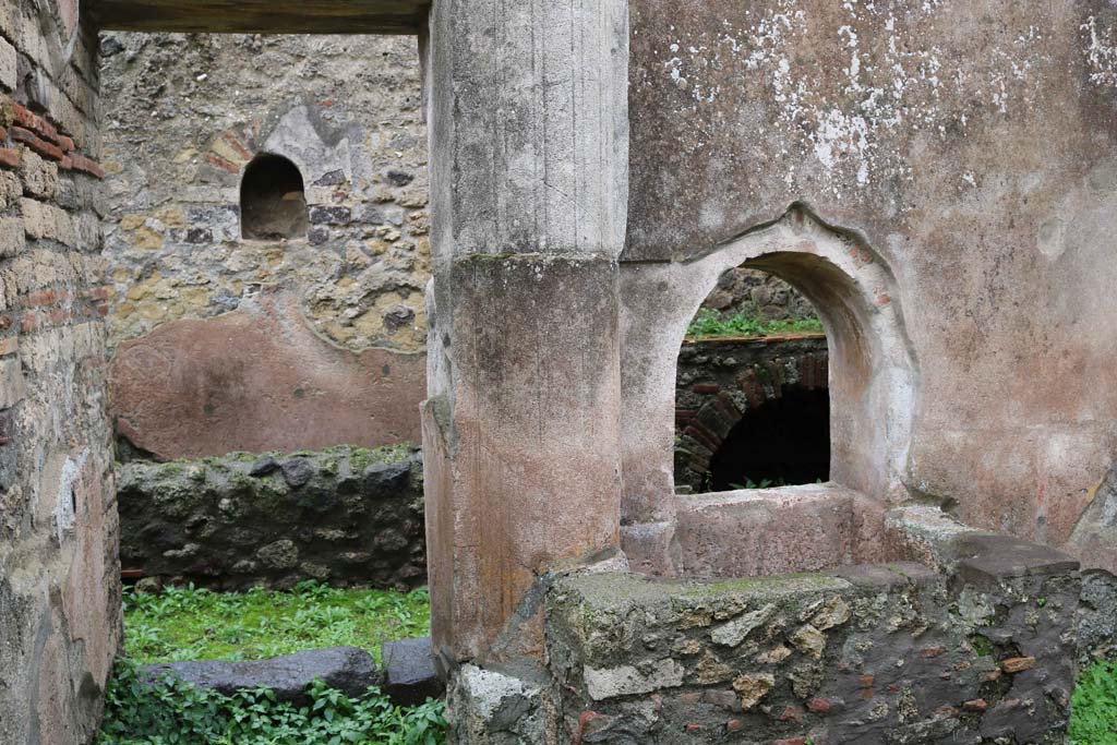 VIII.4.4 Pompeii. December 2018.
Looking east to doorway to room 7, with square basin beneath arched opening, on the south side. Photo courtesy of Aude Durand.
According to Boyce –
In the kitchen opening off the east side of the peristyle, in the east wall above a masonry tub, is a small arched niche (h.0.47, w.0.36, d.0.27, h. above floor 1.60) adorned with an aedicula façade.
See Boyce G. K., 1937. Corpus of the Lararia of Pompeii. Rome: MAAR 14. (p. 76, no.358).
See Giacobello, F., 2008. Larari Pompeiani: Iconografia e culto dei Lari in ambito domestico. Milano: LED Edizioni, (p.199, no.89)