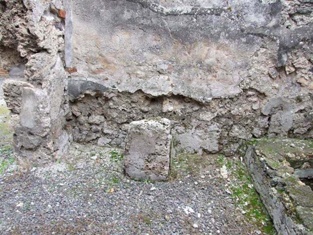 IX.1.12 Pompeii. December 2007. South wall and south-east corner near doorway of kitchen. Masonry altar.
According to Boyce, the lararium painting was done on a white background.
When he wrote his book in 1937, he said that on the right and left, the legs of the figures of the Lares were preserved.
In the middle was the lower part of Venus Pompeiana wearing a yellow chiton and blue mantle.
In her left hand she held a sceptre, and her right rested on a rudder.
At her side was a cupid who seemed to be leaning forward to touch the garment of the goddess.
Below this, the two serpents confronted at a painted altar.
On the floor below the painting a masonry altar stands against the wall.
See Boyce G. K., 1937. Corpus of the Lararia of Pompeii. Rome: MAAR 14. (p.79)
See Giacobello, F., 2008. Larari Pompeiani: Iconografia e culto dei Lari in ambito domestico. Milano: LED Edizioni. (p.204, no.96).
Remains of the altar and household shrine recorded by Helbig: Kitchen: Venus Pompeiana and Gods, 66?
See Helbig, W., 1868. Wandgemälde der vom Vesuv verschütteten Städte Campaniens. Leipzig: Breitkopf und Härtel. (66).
See Pappalardo, U., 2001. La Descrizione di Pompei per Giuseppe Fiorelli (1875). Napoli: Massa Editore. (p.138)
See Fiorelli, G. (1875). Descrizione di Pompei, (p.370)