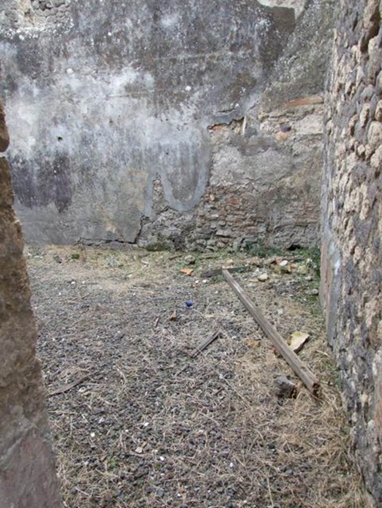 IX.2.16 Pompeii. December 2007. Doorway to room on south side of corridor, described by Boyce as the triclinium. He said that on the north wall was a panel of white stucco bordered in red and within it was the lararium painting in two zones. The two Lares stood in the upper zone, both with rhyton and situla, and the Genius stood between them pouring a libation onto an altar. On the other side of the altar was the tibicen. In the lower zone, one yellow serpent was advancing left towards a painted altar of yellow marble with one egg.
See Boyce G. K., 1937. Corpus of the Lararia of Pompeii. Rome: MAAR 14. (p.81, no.394)
According to Trendelenburg in BdI, “from the fauces, a side door gave access to a square room. The original decoration was not conserved, other than some traces of figurines placed in the red and black divisions on the wall, and the painted lararium divided into two zones”.
See Trendelenburg in BdI, 1871, (p.201)
According to Fiorelli, “Dal tablino, e dalla fauce che vi si trova accanto, nel cui estremo e situato il triclinio, si passa nel giardino, che ha un larario…….” “From the tablinum, and from the corridor that one finds nearby, in whose extremity was situated the triclinium, one passes into the garden, that had a lararium with the painting of a Genius sacrificing being assisted by a tibicen. There were also two Lares and a serpent advancing towards the table. Following on was a storeroom (apotheca), a masonry staircase to the upper floor, the kitchen and the latrine, placed beneath the abovementioned stairs, and another room, occupied perhaps by a servant that guardedthe door”.
See Pappalardo, U., 2001. La Descrizione di Pompei per Giuseppe Fiorelli (1875). Napoli: Massa Editore. (p.142-3)
See Fiorelli, G., 1875. Descrizione di Pompei, (p.384)
According to Giacobello, the picture was in an apotheca (o) on the north wall, but is no longer visible, only Boyce’s description remains.
See Giacobello, F., 2008. Larari Pompeiani: Iconografia e culto dei Lari in ambito domestico. Milano: LED Edizioni. (p.204-5)