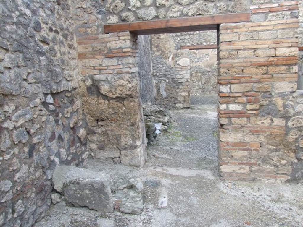 IX.3.13 Pompeii. March 2009. North wall of caupona, with remains of stairs in north-west corner, and doorway to dwelling.
On the west wall, on the left, under the stairs would have been a lararium painting, now disappeared.
Luckily both Fiorelli and Sogliano wrote a good description.
Fiorelli told us that there was a Genius flanked by Lares, the caricature of a male head, and two gladiators in combat.
Sogliano reported that the painting was done in red monochrome on white plaster, and showed a Genius with patera and cornucopia, sacrificing at the altar in the middle of two Lares with rhyton and situla.
See Pappalardo, U., 2001. La Descrizione di Pompei per Giuseppe Fiorelli (1875). Napoli: Massa Editore. (p. 146).
See Sogliano, A., 1879. Le pitture murali campane scoverte negli anni 1867-79. Napoli: (p.11).
According to Boyce –
On the wall of the shop is a lararium painting (h.0.80 by w.1.20) representing the Genius with cornucopia and patera beside an altar and on each side a Lar with rhyton and situla.
See Boyce G. K., 1937. Corpus of the Lararia of Pompeii. Rome: MAAR 14. (p.83-4, no. 411).
See Jacobelli, L., 2003. Gladiators at Pompeii. Rome: L’Erma di Bretschneider. (p. 82).