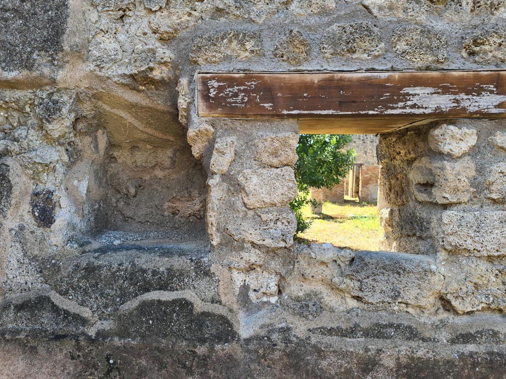 IX.6.7 Pompeii. May 2024.
Kitchen “p”, west wall at south end with window onto peristyle of IX.6.5, and in the same corner a niche (0.40 high x 0.33 wide) that could have been used as a lararium or for putting a light, or for the figurines of the Lares: a lararium painting was not found.
See Mau in Bullettino dell’Instituto di Corrispondenza Archeologica (DAIR), 1880, (p.231).
See Boyce G. K., 1937. Corpus of the Lararia of Pompeii. Rome: MAAR 14. (p.86, no. 431).
Photo courtesy of Klaus Heese.