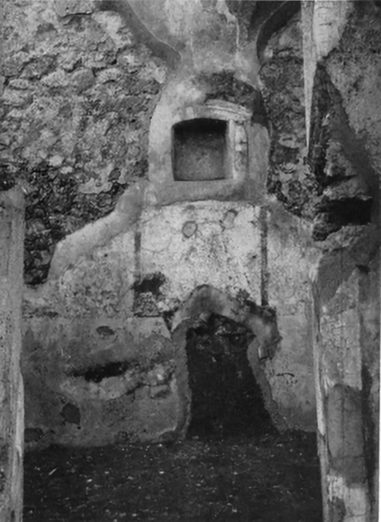 IX.6.g Pompeii. Niche set into west wall of room in north-west corner of peristyle.
According to Boyce –
in a small room in the north-west corner of the peristyle, in the middle of the west wall was an arched niche (h.0.32, w.0.31, d.0.15, h. above floor 1.42).
This was adorned with an aedicula façade of applied half-columns on each side supporting a cornice.
The cornice ran around the curve of the arch instead of a pediment.
The lower half of each column was red, the upper half white.
The inside walls of the niche were decorated with many small irregular blotches of red on a white background.
See Bullettino dell’Instituto di Corrispondenza Archeologica (DAIR), 1881, p. 23.
See Boyce G. K., 1937. Corpus of the Lararia of Pompeii. Rome: MAAR 14. (p. 87, no.435 and Pl.3, 6).
