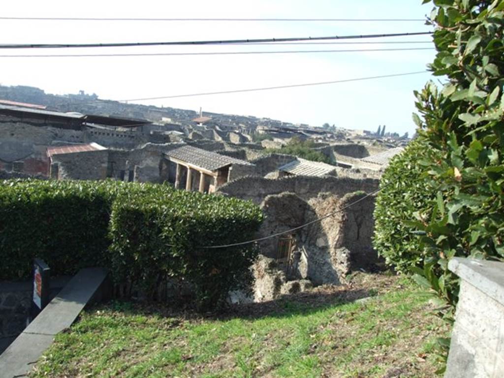Looking north-west from Casina dell’ Aquila to rear of IX.7.14. December 2007. According to Boyce and Jashemski, a garden was excavated near here. The west wall of the garden can be partially seen on the right side of the doorway of IX.7.14. Whether it belonged to IX.7.12, 14, or 16 cannot be seen until further excavation. See Boyce G. K., 1937. Corpus of the Lararia of Pompeii. Rome: MAAR 14. (p.89, no.445) According to Jashemski, she quoted the location as IX.7.12(?). She said in the north-west corner of this partially excavated garden, at the left of the entrance, stood an aedicula lararium. In front of the lararium was a small altar, and a lararium painting on the wall around the shrine. Many marble sculptures decorated the garden. See Jashemski, W. F., 1993. The Gardens of Pompeii, Volume II: Appendices. New York: Caratzas. (p.239)