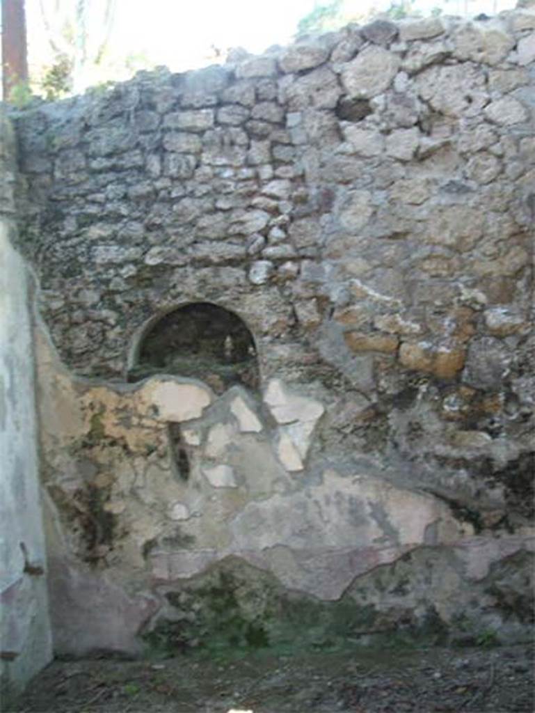 IX.7.20 Pompeii. May 2005. Niche in kitchen, room (p).
According to Boyce, in the west wall of the kitchen, in the south-west corner of the house, was once a niche.
This niche was coated with white stucco but was subsequently bricked-up.
See Boyce G. K., 1937. Corpus of the Lararia of Pompeii. Rome: MAAR 14. (p.88, no.440)
See Giacobello, F., 2008. Larari Pompeiani: Iconografia e culto dei Lari in ambito domestico. Milano: LED Edizioni. (p.210, no.107)
