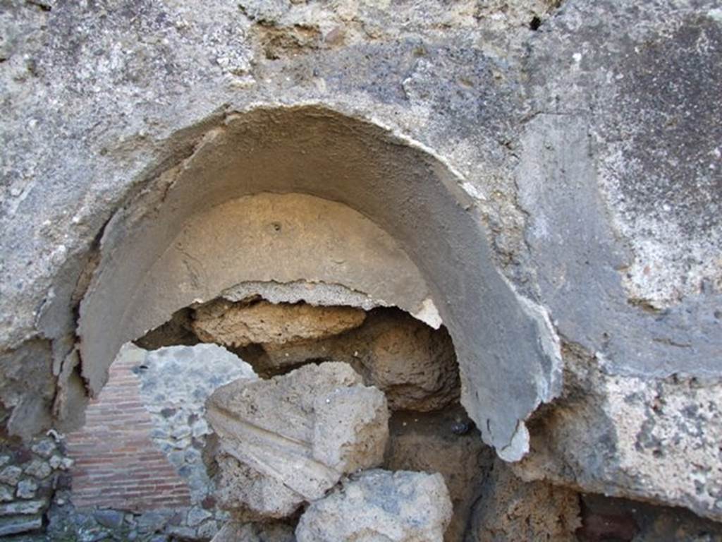 IX.9.1 Pompeii. March 2009. Remains of niche.
According to Boyce –
In the west wall is a vaulted niche (h.0.43, w.0.42, d. varies from 0.17 to 0.21, h. above floor 1.20).
Its inside wall were coated with white stucco.
He quoted Notizie degli Scavi di Antichità, 1888, 514 as his source.
See Boyce G. K., 1937. Corpus of the Lararia of Pompeii. Rome: MAAR 14. (p.90 no. 453)