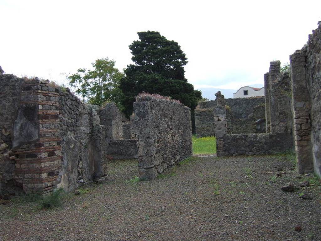 IX.9.4 Pompeii. May 2006.
Looking south across atrium, with doorway to room ‘g’, triclinium, left of centre, and doorway from room ‘f’, tablinum to garden.
According to Boyce –
In the north wall of the portico which looks out onto the garden from the north side, is a vaulted niche (h.0.40, w.0.40, d.0.12, h. above floor 1.60) – probably the lararium, according to Mau. On the ground before it lies a cube of travertine (0.24) which may have served as altar.
See Boyce G. K., 1937. Corpus of the Lararia of Pompeii. Rome: MAAR 14. (p.91, no.455).
See Giacobello, F., 2008. Larari Pompeiani: Iconografia e culto dei Lari in ambito domestico. Milano: LED Edizioni, (p.286 no.V82)