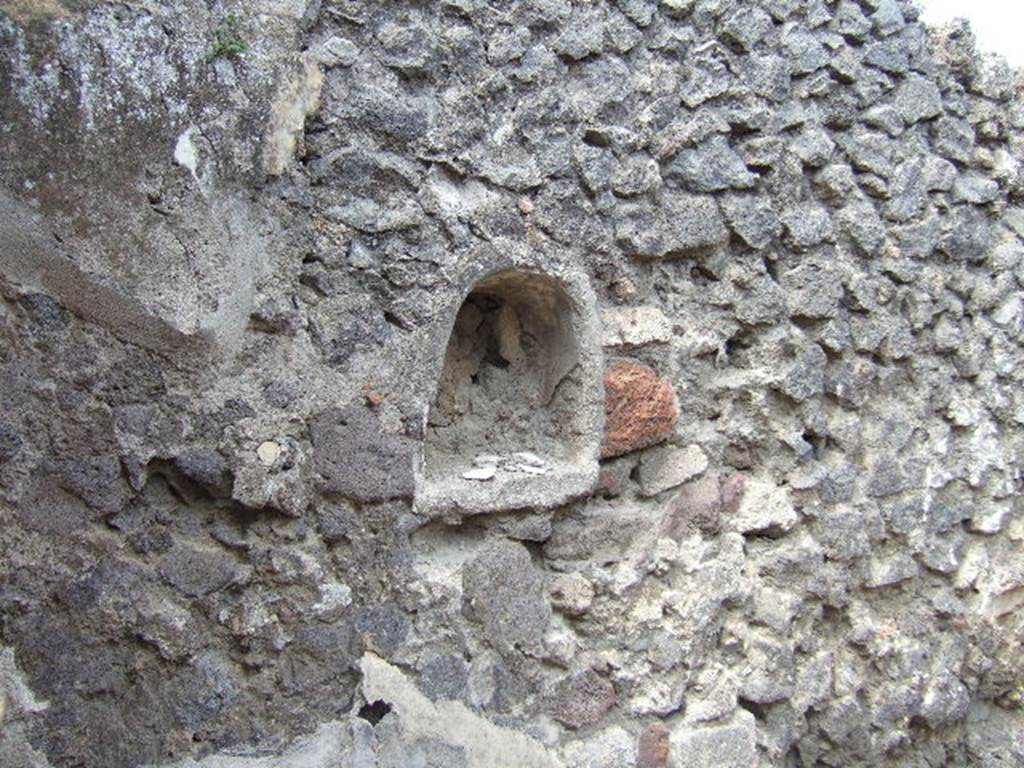 IX.9.6 Pompeii. May 2006. Niche in west wall of cubiculum.
According to Boyce –
this niche (h.0.45, w.0.41, d.0.18, h. above floor 1.27) had walls coated with white stucco decorated with green, yellow and violet spots, probably representing flowers.
See Boyce G. K., 1937. Corpus of the Lararia of Pompeii. Rome: MAAR 14. (p. 91 no. 457)