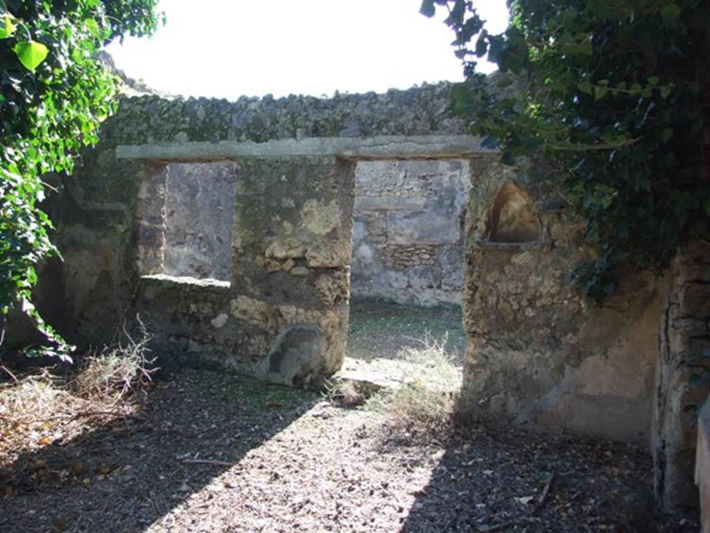 IX.9.11 Pompeii. March 2009. Niche on west wall of atrium, with doorway and window to Room 6, Garden.