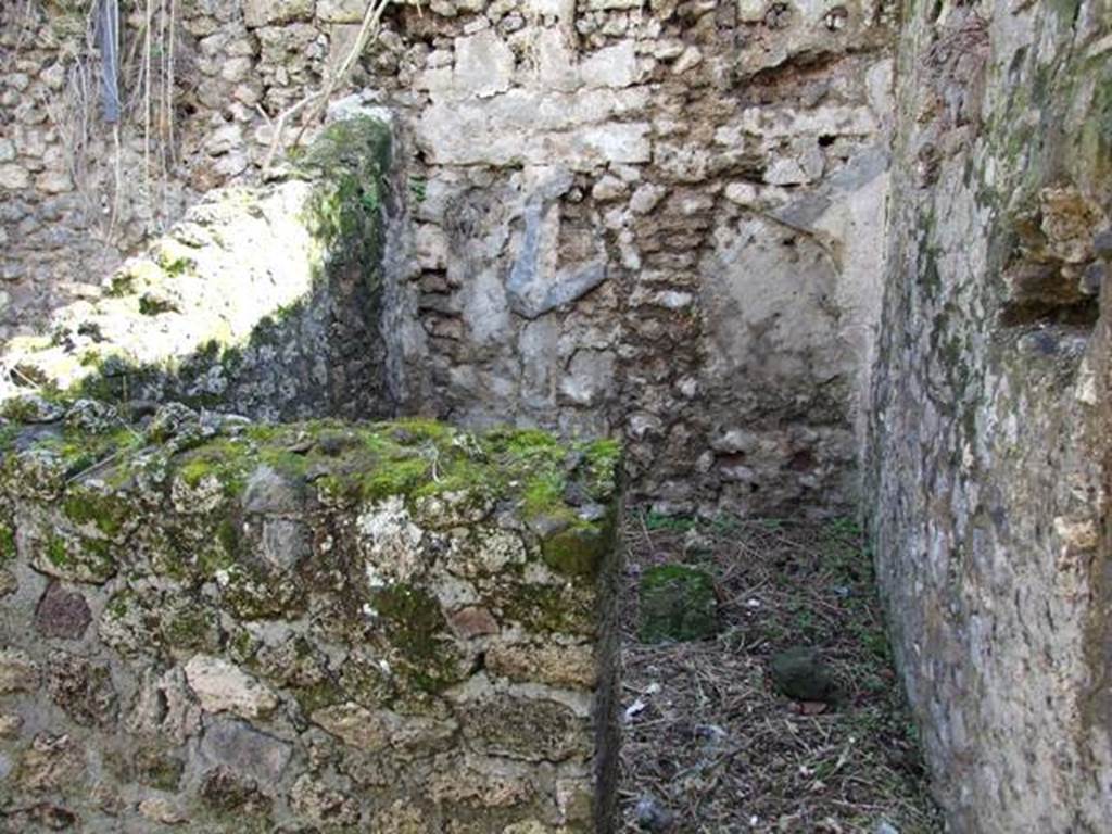 IX.9.g Pompeii. March 2009. Looking south into doorway into cubiculum on south side of entrance atrium. On the left would be the east wall of the cubiculum, and straight ahead would be the south wall. The small hearth in the kitchen area would have been in the area behind the east wall, on the left. Boyce’s west wall would have been the other side of this “east wall”. According to Boyce, the hearth stood against the south wall of the atrium and on the west wall near it was the lararium painting. Found in the cubiculum on the right of the entrance doorway was a small altar composed of a terracotta cylinder supporting a square plate of travertine.
See Boyce G. K., 1937. Corpus of the Lararia of Pompeii. Rome: MAAR 14. (p.94, no.469)
According to Giacobello, on the south wall of kitchen (e) was a lararium painting (not conserved). Perhaps this does not apply to this house, as it is headed IX.9.7, (IX.9.g?)
See Giacobello, F., 2008. Larari Pompeiani: Iconografia e culto dei Lari in ambito domestico. Milano: LED Edizioni. (p.216)