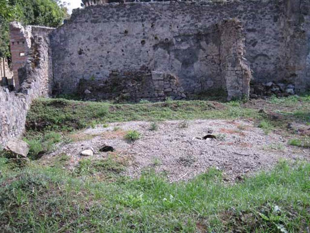 I.2.24 Pompeii. September 2010.
Looking south across peristyle over remains of the triclinium, towards the three rooms on the south side.
On the left could be the remains of the altar base. Photo courtesy of Drew Baker.