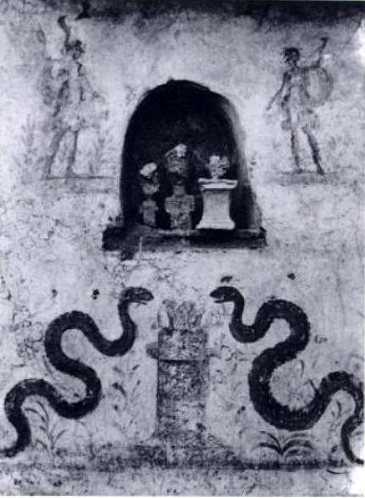 I.8.18 Pompeii. Old photo of lararium on the south wall in the kitchen.
According to Giacobello, this is the lararium in the kitchen of I.8.18.
She shows a contemporary photograph to confirm this.
See Giacobello, F., 2008. Larari Pompeiani: Iconografia e culto dei Lari in ambito domestico. Milano: LED Edizioni. (p.142).
PPM shows a similar contemporary photograph in I.8.18. This old lararium photo however is shown as I.8.17 in PPM.
See Carratelli, G. P., 1990-2003. Pompei: Pitture e Mosaici: Vol. 1. Roma: Istituto della enciclopedia italiana, p. 918, n. 7; p. 853, n. 13.
According to Fröhlich, in a 1941 archive photograph it was said to be in the atrium of I.8.17 Casa dei Quattro Stili.
He considered the niche remaining in I.8.17 did not have enough room on its left side to fit in the left Lar and serpent.
He attributed it to an unspecified house in insula I.8, because from 1937 to 1941 this was the only place excavations took place.
He describes a white-ground painted wall surface with an arched niche. The niche is located roughly in the centre of the wall and is flanked by two Lares, each with a small plant at their feet. A round altar is painted below the niche, flanked by two diagonally ascending snakes. Oleander-like plants fill the background. A small altar made of terracotta and two primitive-looking tuff busts with angular arm stumps were placed in the niche, probably the imagines maiorum.
See Fröhlich, T., 1991. Lararien und Fassadenbilder in den Vesuvstädten. Mainz: von Zabern. (L10, p.254, Taf. 25,3).