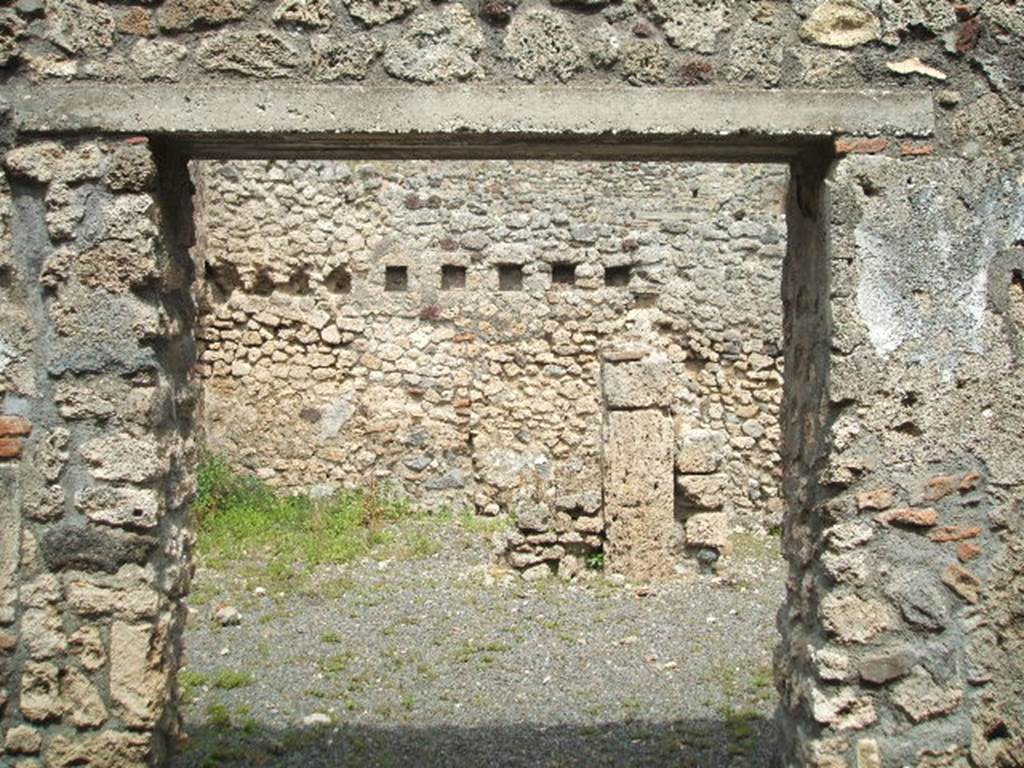 V.2.f Pompeii. May 2005. Entrance, looking east. According to NdS, the atrium was devoid of an impluvium, but to the right of where one entered was a small hearth. Above the hearth was a semicircular niche and a short distance away, in the south-west corner of the atrium, was a latrine which would have been protected by a lean-to roof. See Notizie degli Scavi, 1896, (p.436. See Mau in BdI, VIII, 1893, (p.7-9)
According to Boyce, just to the right of the entrance against the west wall in the atrium stood a low masonry altar. Traces of fire were seen on the top of the altar when it was first excavated. Above the altar was an arched niche in the wall.
When Boyce wrote (1937) he said “the last layer of plain white stucco has fallen from the interior walls, revealing a finer layer beneath it” This was white and decorated with red spots. Not photographed yet, it may not be still there. See Boyce G. K., 1937. Corpus of the Lararia of Pompeii. Rome: MAAR 14. (p.36, 103)
According to Giacobello, the hearth was located near the niche in the south corner of the atrium. On the same west wall, to the left of the Lararium is a second smaller niche, and also a trace of a third niche to the left again. See Giacobello, F., 2008. Larari Pompeiani: Iconografia e culto dei Lari in ambito domestico. Milano: LED Edizioni. (p.164 with photo).