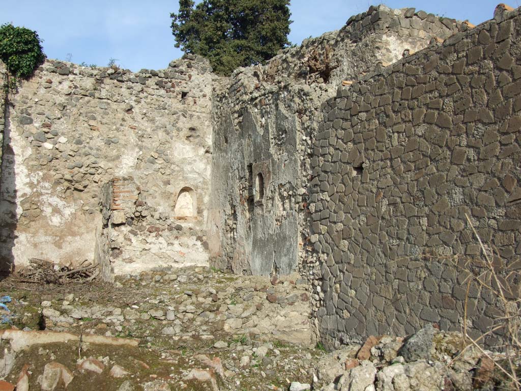VI.1.1 Pompeii. December 2007. Looking towards north-east corner with two niches.
On the north wall was a niche that had been in the remains of a windowless sacrarium
On the east wall was another niche which was outside the sacrarium, at the end of a passage from the triclinium.