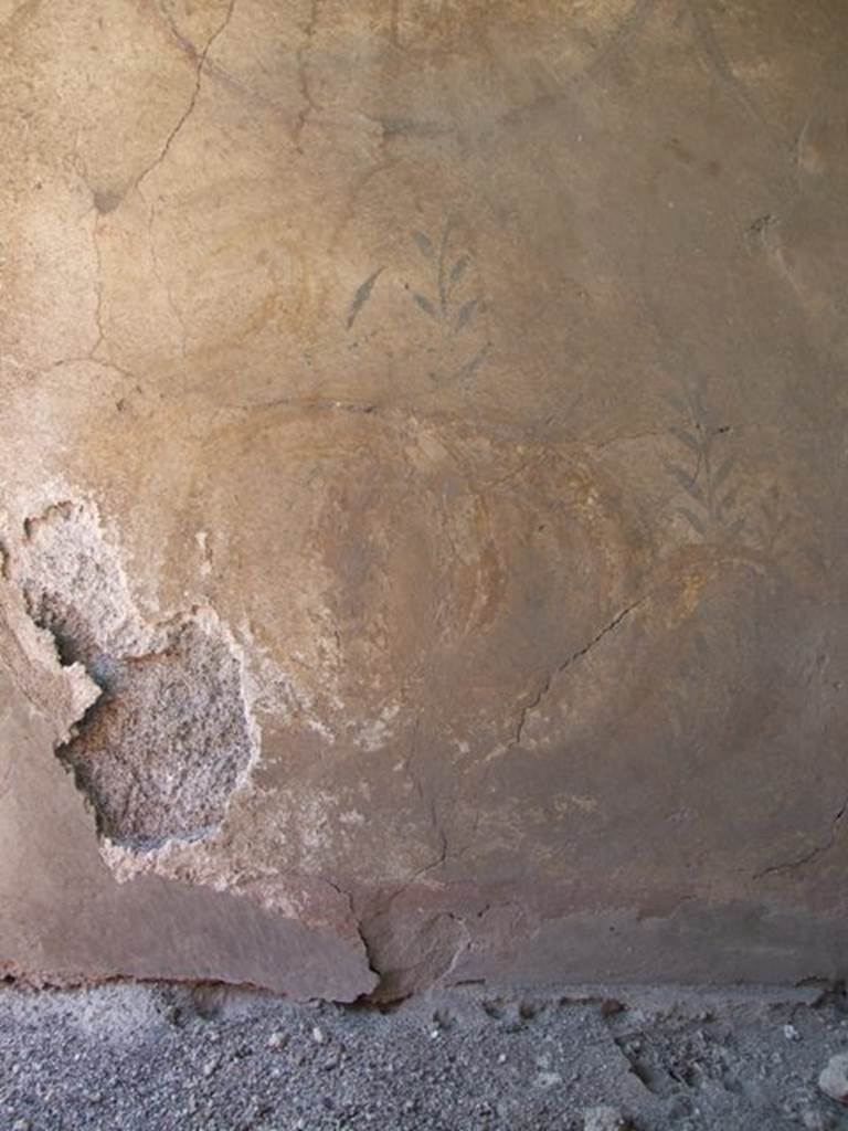 VI.7.6 Pompeii. March 2009. West wall, painting of coils of serpent and remains of plants. According to Boyce, on each of the side walls was a painting of a serpent, coiling towards an altar with two eggs and a pine cone on it. See Boyce G. K., 1937. Corpus of the Lararia of Pompeii. Rome: MAAR 14. (p.47, no.162 and Pl.30,1)