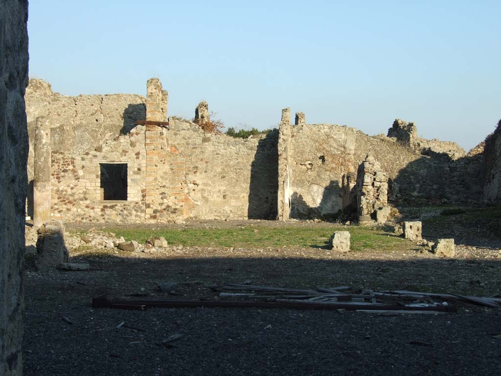 VI.14.38 Pompeii. December 2007. Site of tablinum, and peristyle, looking east to rear rooms.
Jashemski reported that the middle panel of the right (south) wall of the tablinum, instead of having the usual large painting, was plain yellow and contained a small garden scene.
This was reported but not described by Mau.
The left (north) wall was almost completely destroyed at the time of the eruption.
See Jashemski, W. F., 1993. The Gardens of Pompeii, Volume II: Appendices. New York: Caratzas. (p.398, with ref: Mau, BdI (1878), p.115)
According to Jashemski, the peristyle garden at the rear of the tablinum would have been visible from the entrance.
The tablinum would have been completely open on both its east and west ends.
The garden was enclosed on the north, west and south sides by a portico, supported at the time of the eruption by nine columns.
There was a cistern opening without a puteal on both the north and south sides between the two west columns.
In the garden were two marble table supports, and a monopodium without the basin which it probably supported.
In the south-west corner of the peristyle were the ruins of an arched niche.
See Jashemski, W. F., 1993. The Gardens of Pompeii, Volume II: Appendices. New York: Caratzas. (p.150-51)
According to Boyce, in the south-west corner of the peristyle were the ruins of an arched niche, with heavy projecting floor.
See Boyce G. K., 1937. Corpus of the Lararia of Pompeii. Rome: MAAR 14. (p.53, no.205)
See Giacobello, F., 2008. Larari Pompeiani: Iconografia e culto dei Lari in ambito domestico. Milano: LED Edizioni. (p.275)