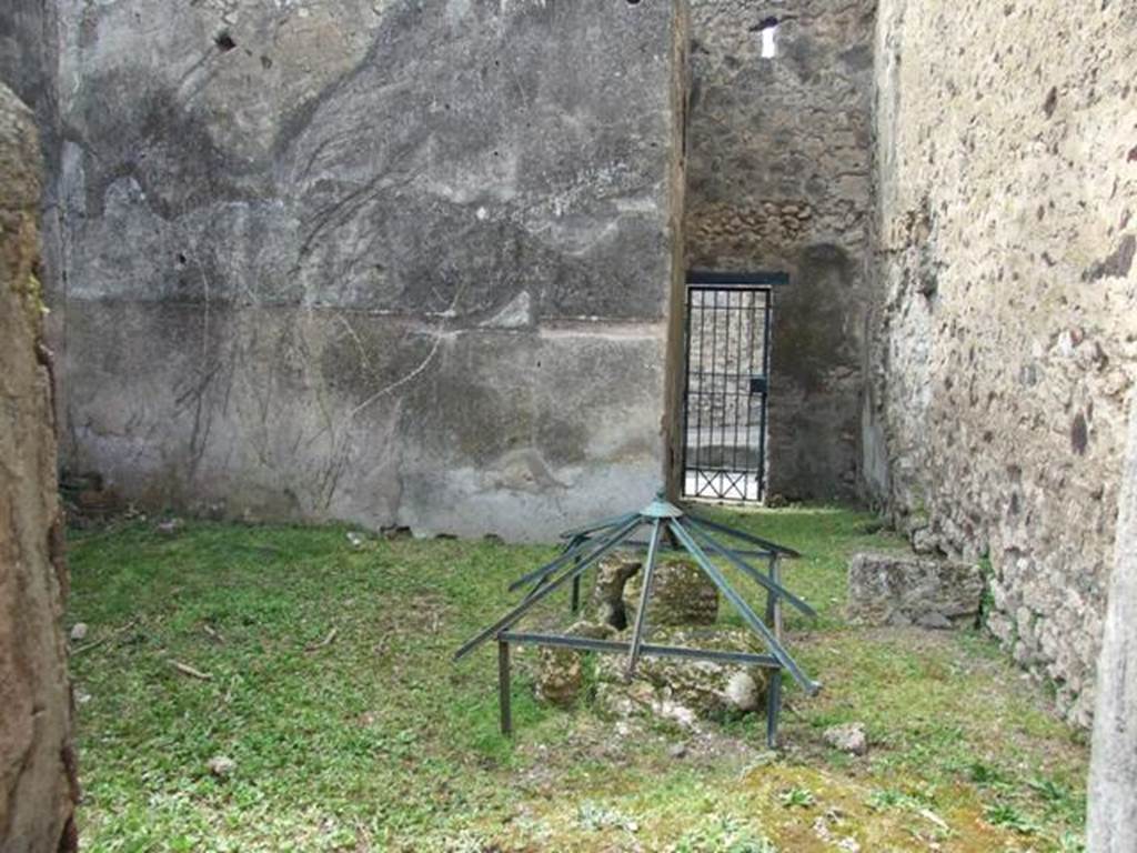 VI.16.29 Pompeii. March 2009. Room O, looking west across to fauces P of entrance VI.16.30. According to NdS, room O was quite spacious and had a rough cocciopesto floor and bare walls, with the usual brick plinth. On the north wall was the base stone of a wooden staircase. In the north-east corner was the cistern mouth. On the extreme right of the west wall was painted on the plinth, from the right to the left, a serpent agatodemone, which approached towards an altar through plants. Found in the soil of this house on the 29th August 1904, but without a precise indication of place, was the upper part of an altar of red marble (m.0.08 x 0.065). See Notizie degli Scavi di Antichità, 1908, (p.284). According to Boyce, in the room entered from the posticum of VI.16.30 was a lararium. It was on the white ground of the dado of the west wall. A single yellow serpent was painted, advancing to the left towards an altar furnished with offerings. In the background were plants. See Notizie degli Scavi di Antichità, 1908, (p.284). See Boyce G. K., 1937. Corpus of the Lararia of Pompeii. Rome: MAAR 14. (p. 59, no 227).
.
