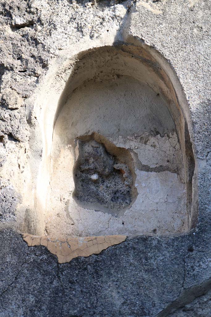 VII.4.49 Pompeii. December 2018.
East wall with niche (h.0.48, w.0.40, d.0.20, h. above floor 1.90) set above the stairs.
Photo courtesy of Aude Durand.
According to Boyce, its inside was coated with white stucco.
It was called by Fiorelli la nicchia de’ Penati.
See Boyce G. K., 1937. Corpus of the Lararia of Pompeii. Rome: MAAR 14. (p. 66, no. 276).