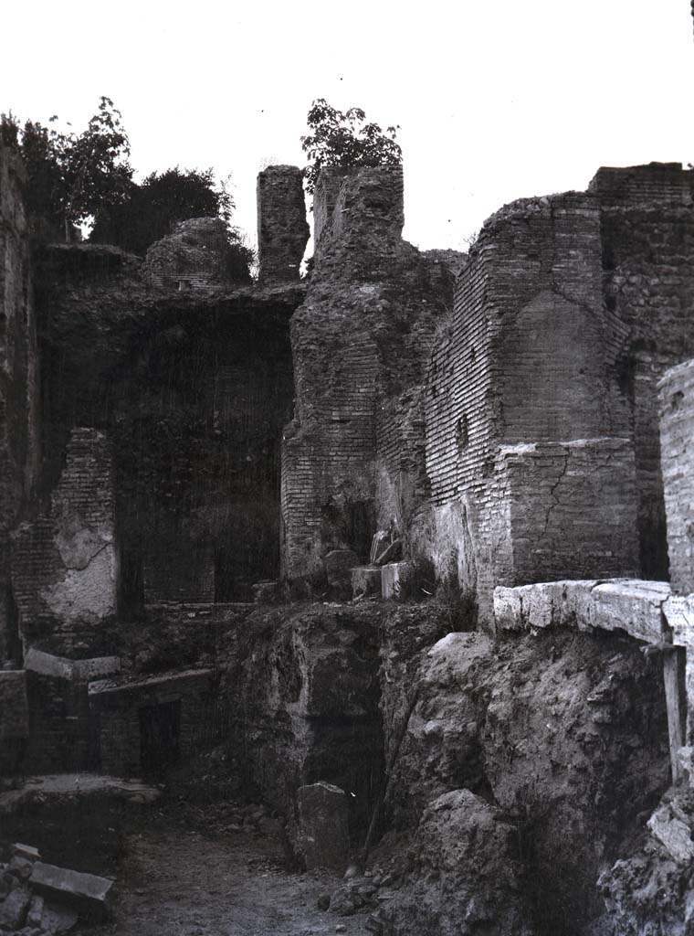 PL.1. Pompeii. Photo by Esther Boise Van Deman (c) American Academy in Rome. VD_Archive_Ph_241.
Description given as Pompeii, Oven, and photo from between 1900-1930.
It does not seem to correspond to any of the ovens in bakeries, the walls look too big to be from a house.
Perhaps the photo is from a Villa, now reburied.
Ostia has been suggested to us, but we wrote to them and they answered that it was not from there.
Espen B Andersson has suggested:
This photo seems to show the entrance to the hypocaust in a Baths building, possibly in Rome.
So much was lost in Rome in the 19th and early 20th century, for instance by the construction in 1936 of the ‘Viale del Monte Oppio’ which goes across Baths of Trajan and made severe damage to the archaeological remains.
Can anyone add anything further as to the identity of this intriguing photograph, as we would love to accurately locate it.