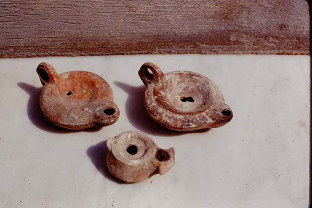 M.1A. Pompeii. 1975. Photo by Stanley A. Jashemski. (Where from originally ? These are the same lamps as below).
Source: The Wilhelmina and Stanley A. Jashemski archive in the University of Maryland Library, Special Collections (See collection page) and made available under the Creative Commons Attribution-Non Commercial License v.4. See Licence and use details.
J75f0577