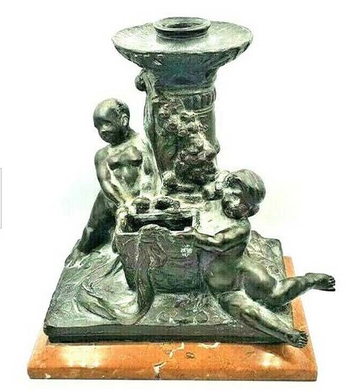 Bronze candlestick. Early 20th century. It has the signature of Gaetano Geraci and the stamp of the Fonderia Artistica Laganà Napoli
The Fonderia Artistica Laganà, one of the most important foundries in Naples, was founded in 1890 by Giovanni Amedeo Laganà, a patron and collector of art, who gathered around him the best specialists in wax casting, chiselling and bronze in Naples.
In 1898, the sculptor Giuseppe Renda became its technical director.
In 1907 the foundry was transformed into a joint-stock company and after the war it devoted itself to large monuments.
It was frequented by the best Italian artists, including Vincenzo Gemito, who died there in 1929 as a result of the heat from a casting he was working on.
The foundry continued its activity until more than the middle of the 20th century.