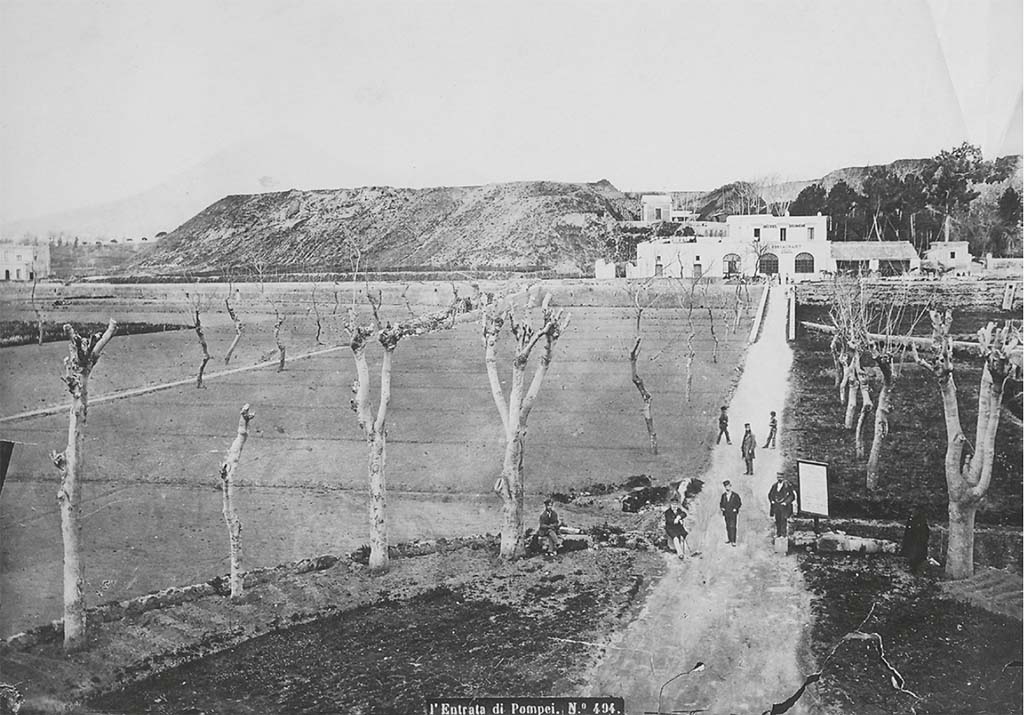 Pre 1889 photo by Roberto Rive (or Giorgio Sommer?), L' Entrata di Pompei, no. 494.
According to Zanella, this shows the entrance to the Pompeii site from the station. Opposite, the Diomede Hotel, taverna del Lapillo.
On the left, the piles of rubble accumulated since the beginning of the excavation outside the urban perimeter on land that belonged to the Irace family and R. Minervini.
Comparing a drawing by Callet (fig. 27) dated 1822 and a photograph by the Alinari brothers dated the hotel seems to retain the old configuration of the taverna del Lapillo. In particular, the three front arcades visible the Callet drawing have been preserved from the old tavern. On the other hand, transformations seem to have taken place on the western part of the building where, instead of the open space that can be seen on the older plans, three doors have been pierced in the blind wall visible in the drawing, confirming the widening of the structure shown in later plans. To the east, already at the time of Callet, a barn leans against the factory building. Another building, visible in the photograph of the Alinari brothers, was added later.
See Zanella S., 2019. La caccia fu buona: Pour une histoire des fouilles à Pompéi de Titus à l’Europe. Naples : Centre Jean Bérard, p. 60, fig. 27 and 28.