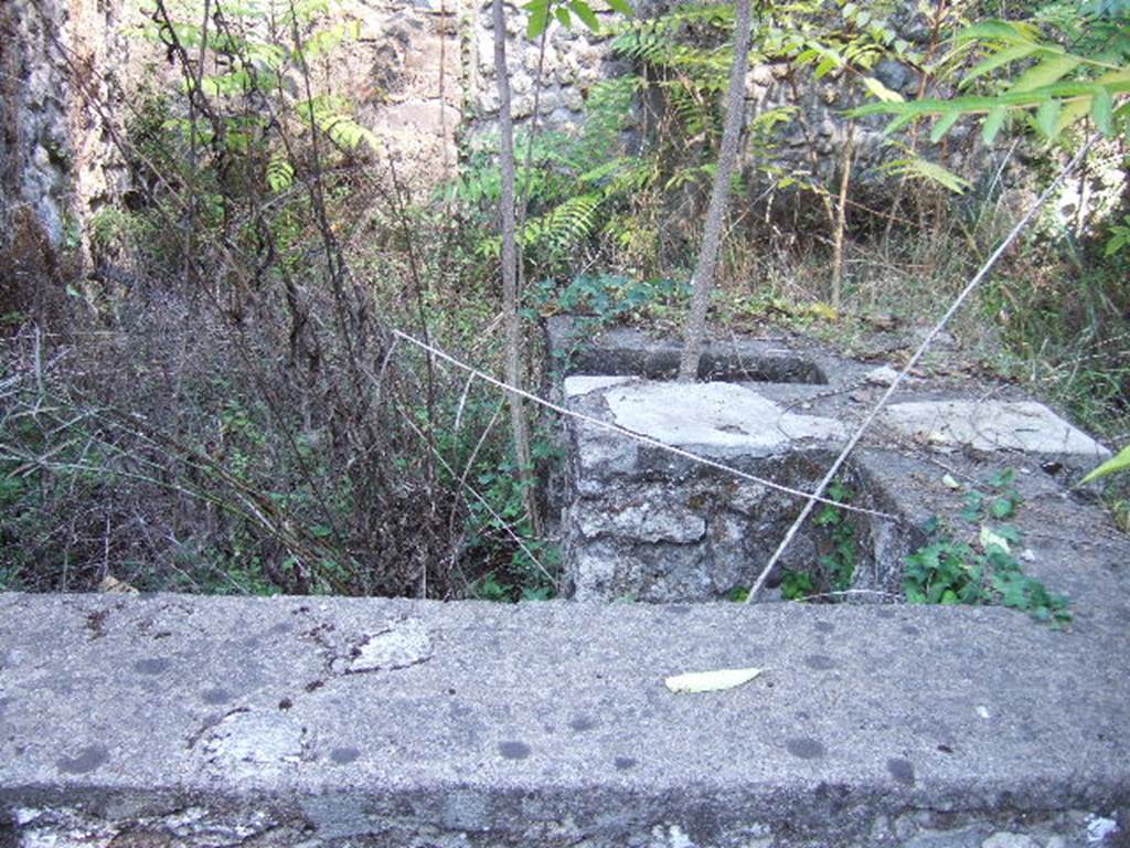 I.1.1 Pompeii. September 2005. Stone podium or sales counter, with kitchen and hearth. There was also a latrine under the steps to the upper floor. (No longer visible).